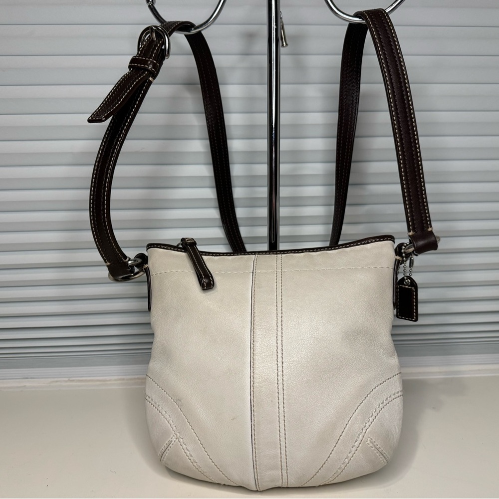 White Coach bag with dark brown strap stitched detail. 8.5 x 8 x 0.5 inch